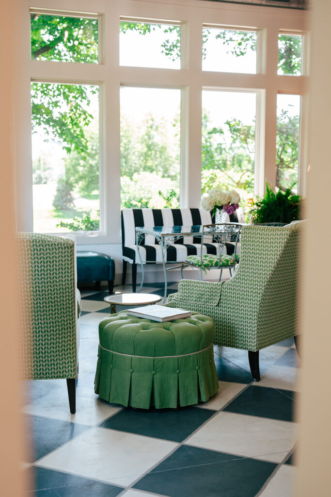 Various chairs in the brightly lit sunroom at Inisfree Estate