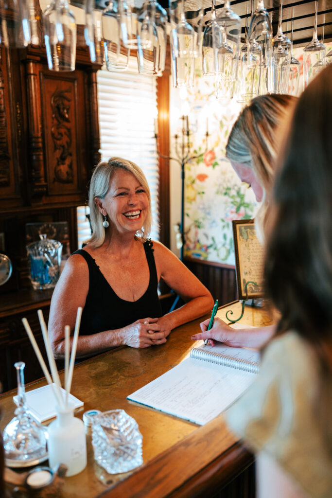 Inisfree Estate innkeeper Peggy checking in guests for their stay
