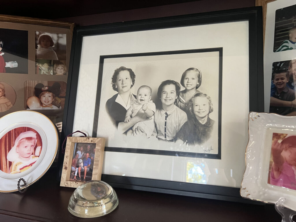 a collection of family photos on a bookshelf